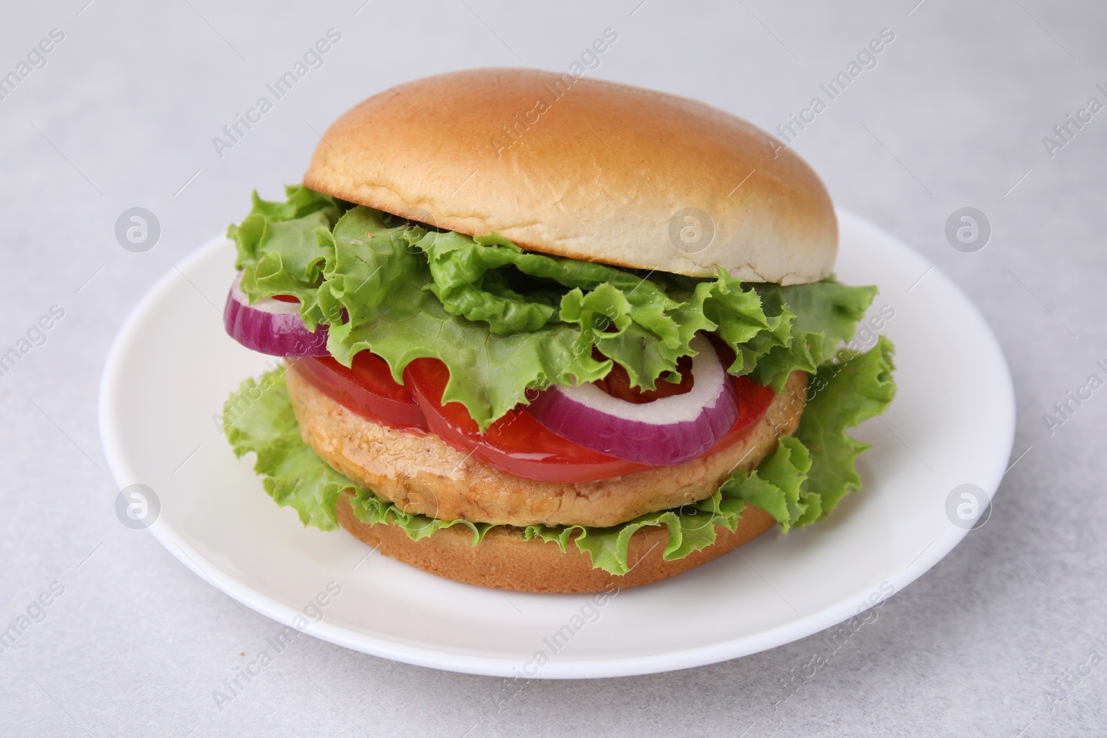 Photo of Delicious vegetarian burger with chickpea cutlet on light table, closeup