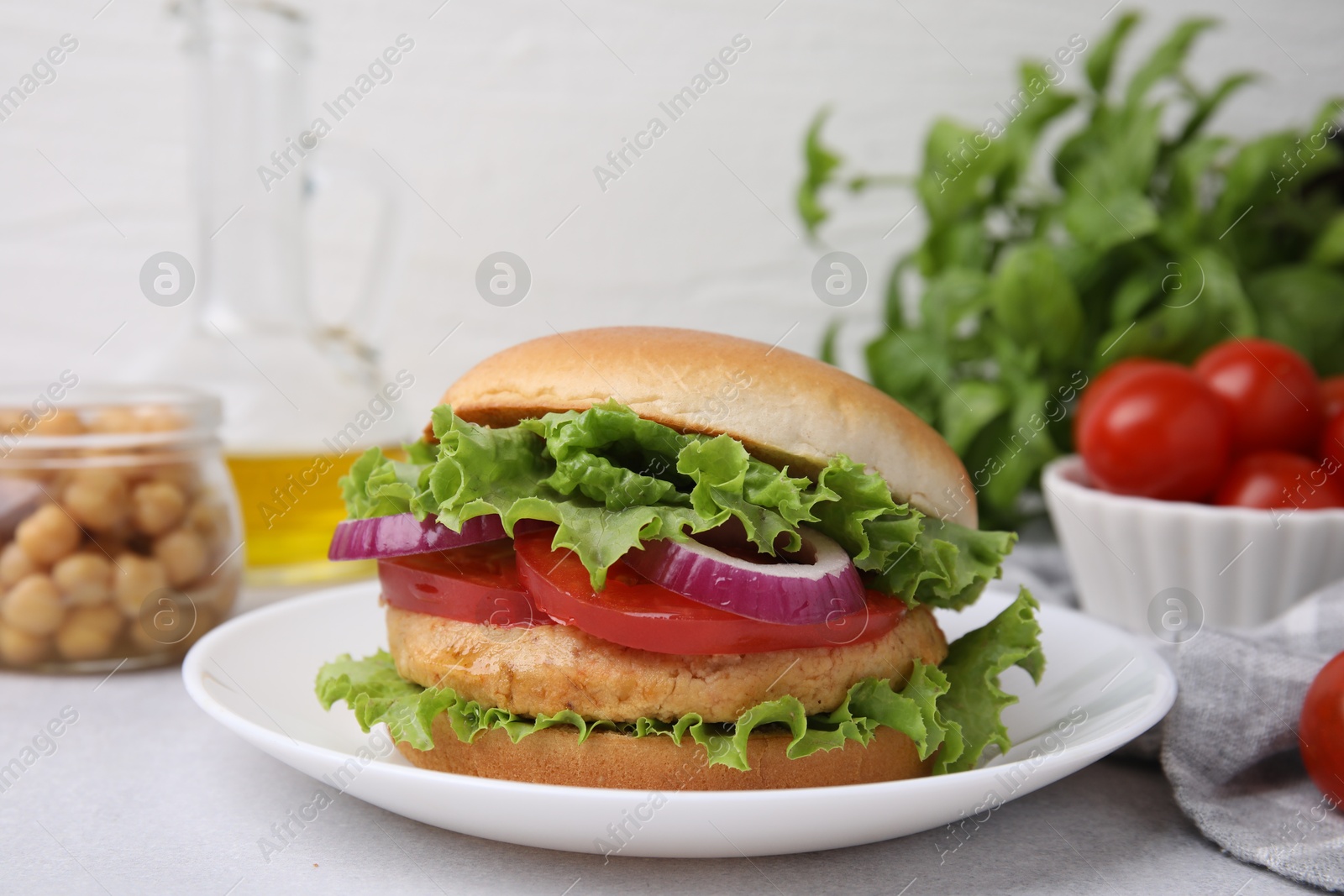 Photo of Delicious vegetarian burger with chickpea cutlet on light table, closeup