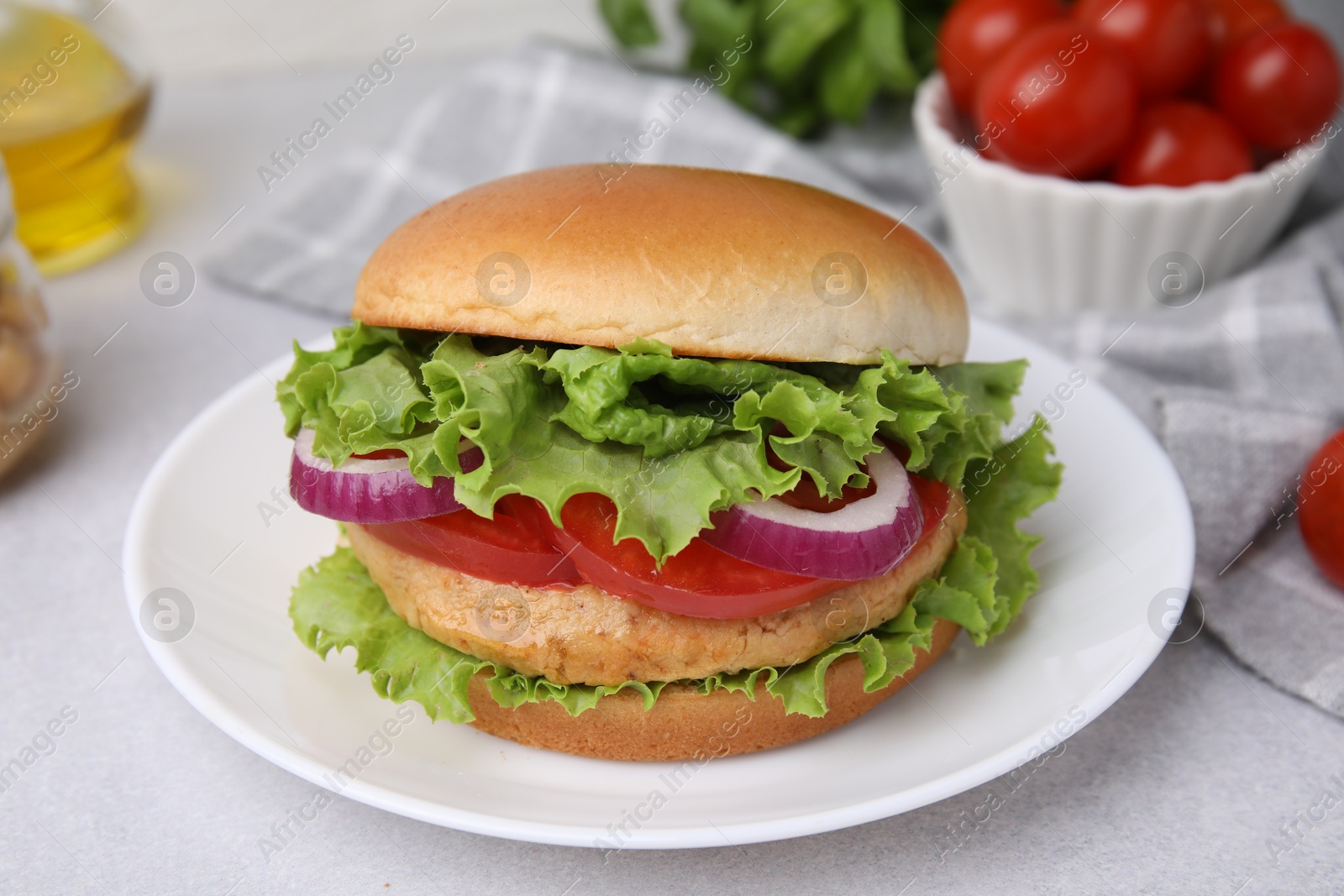 Photo of Delicious vegetarian burger with chickpea cutlet on light table, closeup