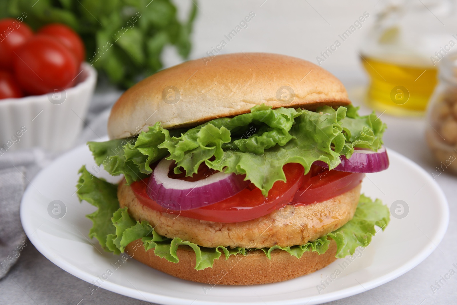 Photo of Delicious vegetarian burger with chickpea cutlet on light table, closeup