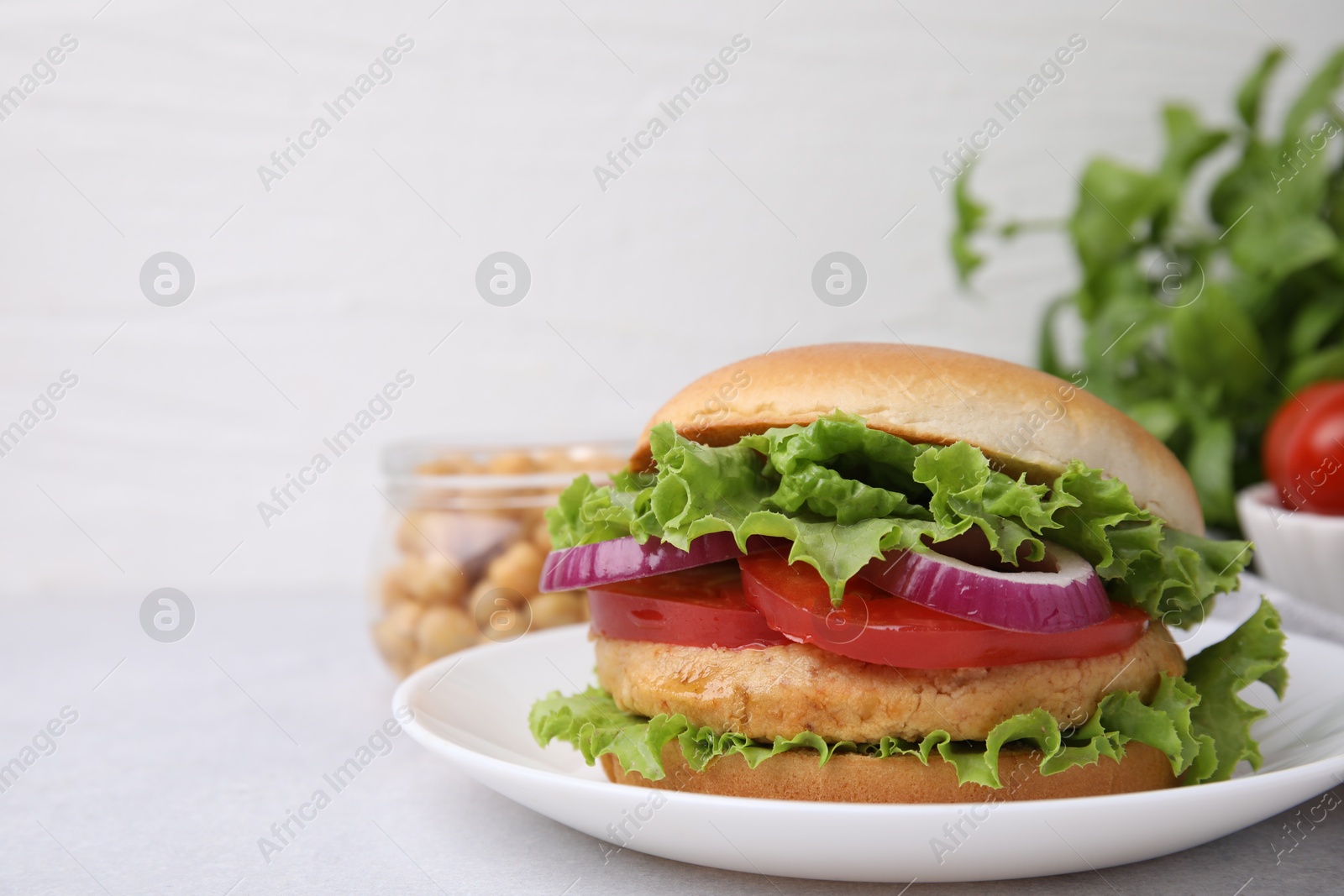 Photo of Delicious vegetarian burger with chickpea cutlet on light table, closeup. Space for text