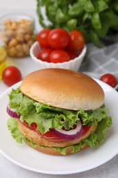 Photo of Delicious vegetarian burger with chickpea cutlet and ingredients on light table, closeup