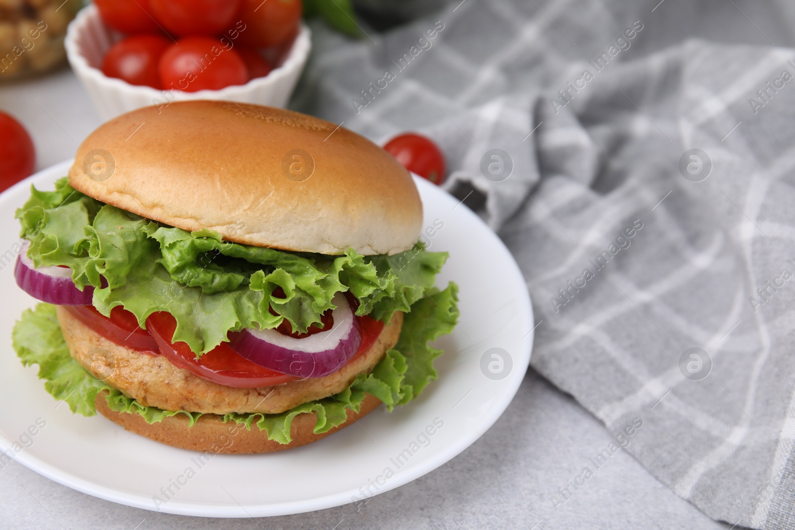 Photo of Delicious vegetarian burger with chickpea cutlet on light table, closeup. Space for text