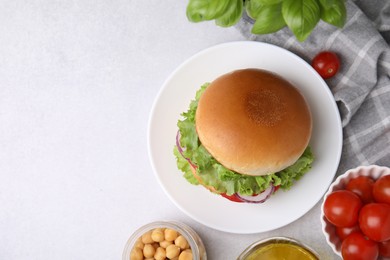 Photo of Delicious vegetarian burger with chickpea cutlet and ingredients on white table, flat lay. Space for text