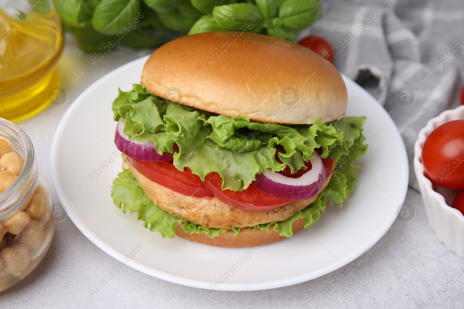 Photo of Delicious vegetarian burger with chickpea cutlet on white table, closeup