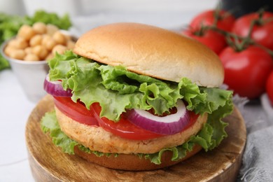 Delicious vegetarian burger with chickpea cutlet on table, closeup