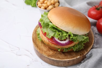 Photo of Delicious vegetarian burger with chickpea cutlet on white table, closeup