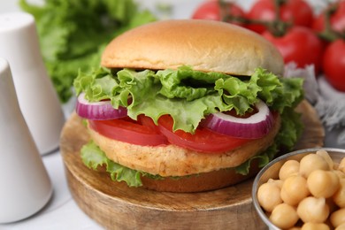 Photo of Delicious vegetarian burger with chickpea cutlet on table, closeup