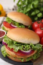 Delicious vegetarian burgers with chickpea cutlets on table, closeup