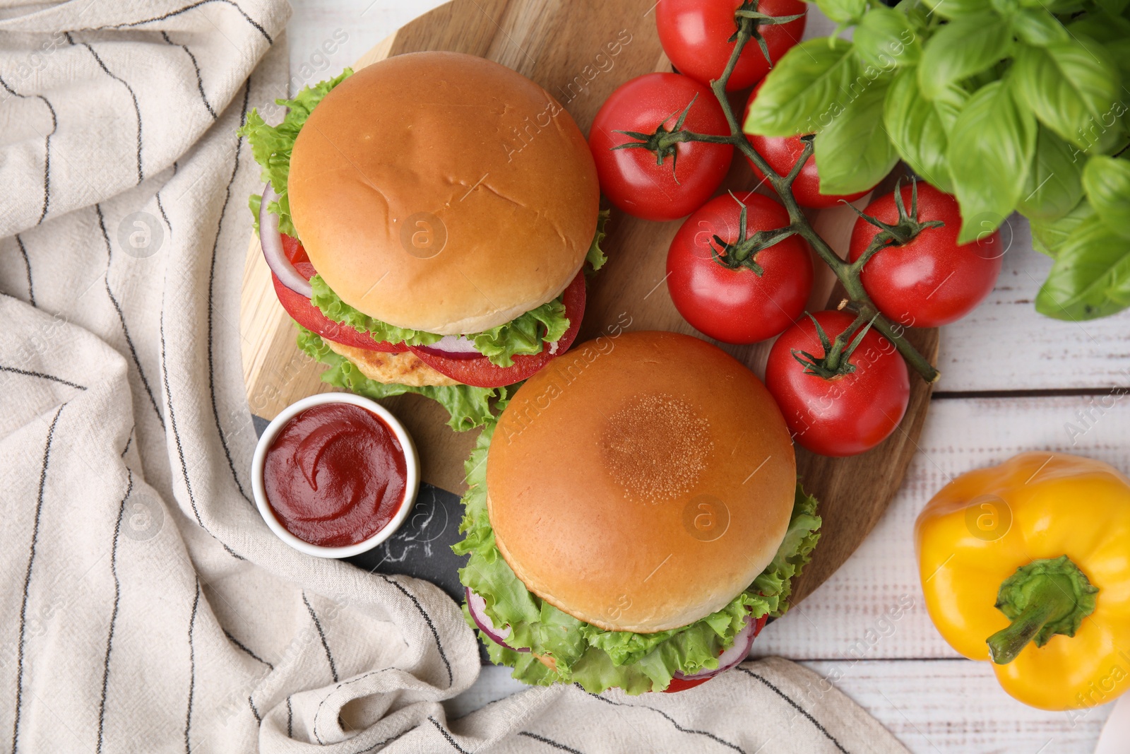 Photo of Delicious vegetarian burgers with chickpea cutlets, ingredients and sauce on white wooden table, flat lay