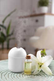 Photo of Essential oil diffuser, cosmetic product and lily flower on table at home