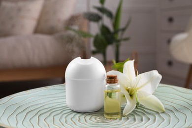 Photo of Essential oil diffuser, cosmetic product and lily flower on table at home