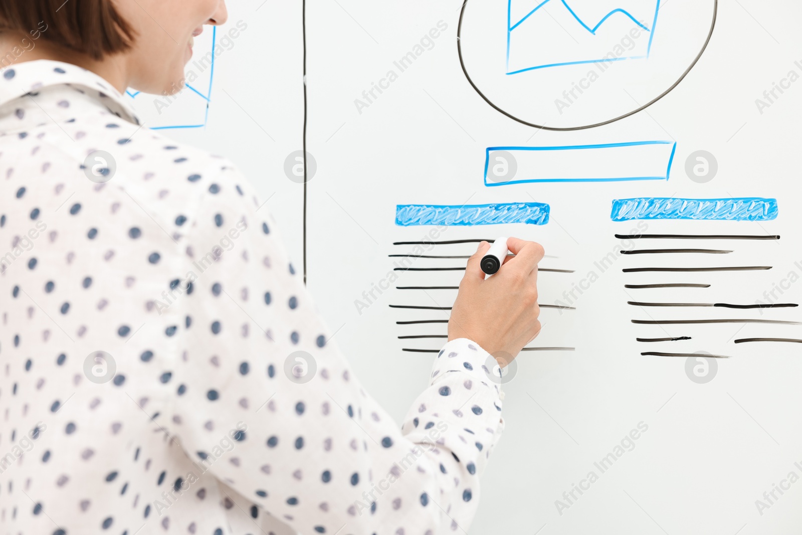 Photo of Developing UI design. Woman drawing website wireframe on whiteboard indoors, closeup