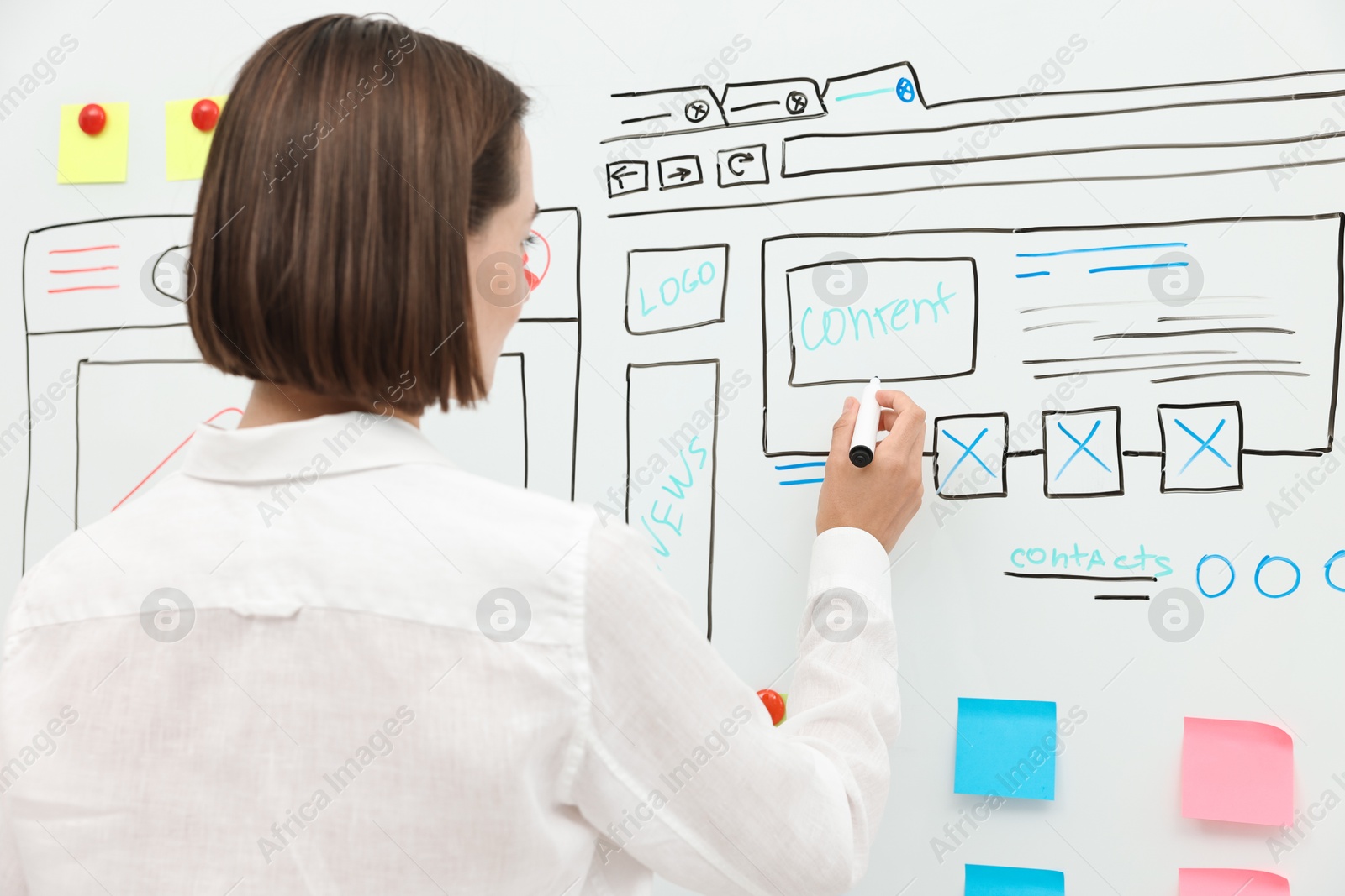 Photo of Developing UI design. Woman drawing website wireframe on whiteboard indoors, back view