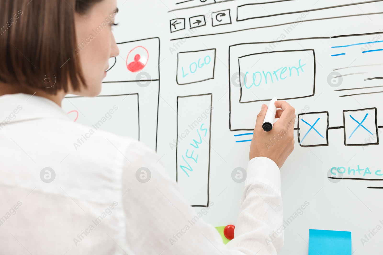 Photo of Developing UI design. Woman drawing website wireframe on whiteboard indoors, closeup