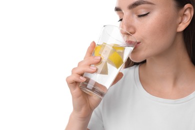 Woman drinking water with lemon on white background, closeup