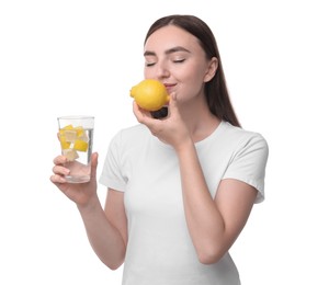 Woman with glass of lemon water and fruit on white background