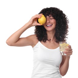 Woman with glass of lemon water and fruit on white background