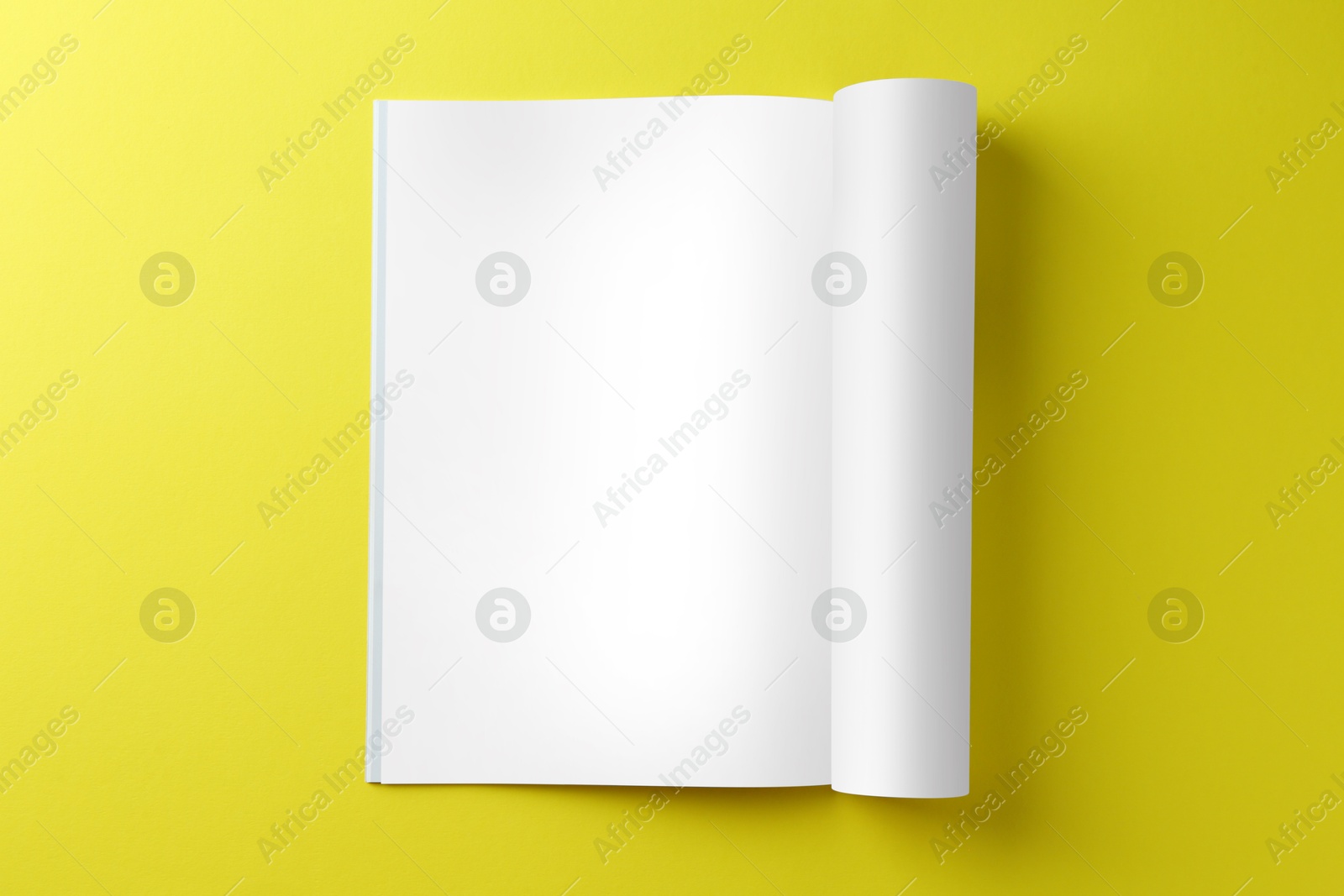 Photo of Open magazine on yellow background, top view. Mockup for design