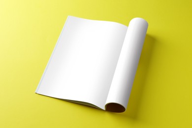 Open magazine on yellow background. Mockup for design