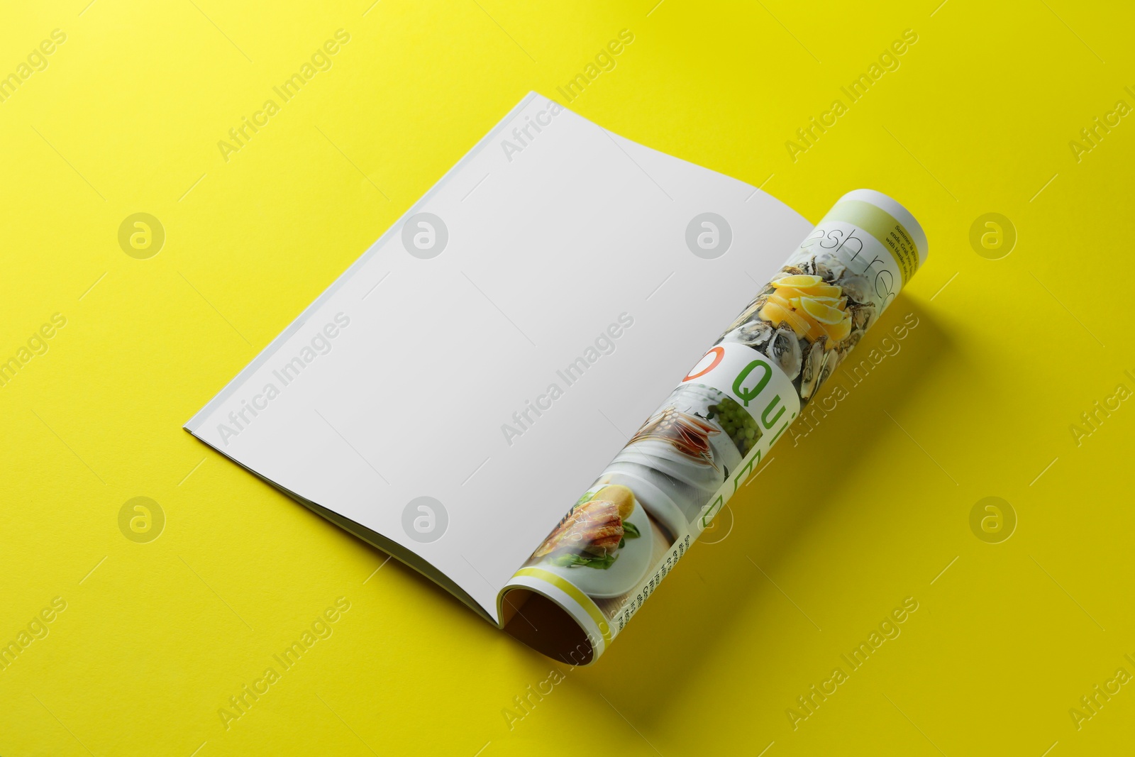 Photo of Open magazine on yellow background. Mockup for design