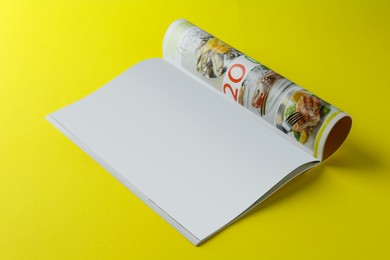 Open magazine on yellow background. Mockup for design