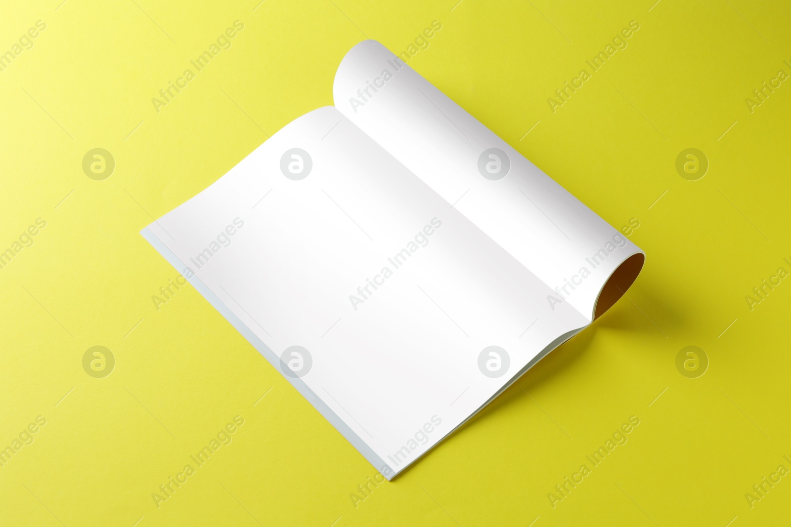 Photo of Open magazine on yellow background. Mockup for design