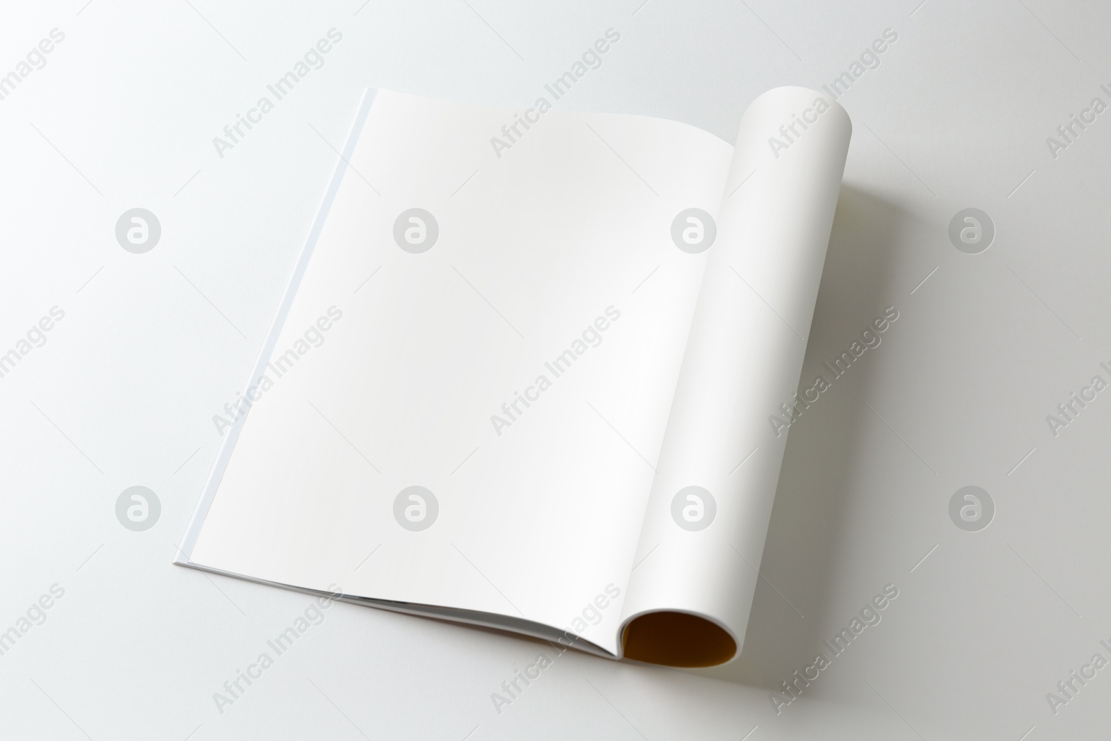 Photo of Open magazine on white background. Mockup for design