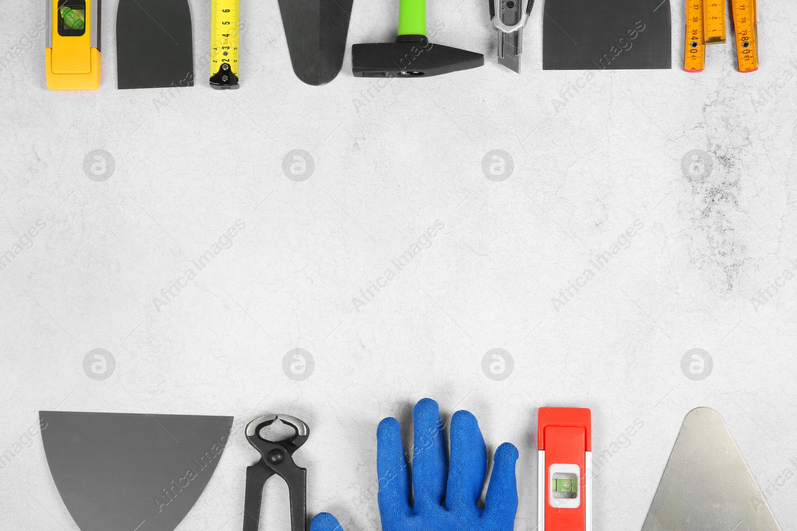 Photo of Many different construction tools on light textured table, flat lay. Space for text