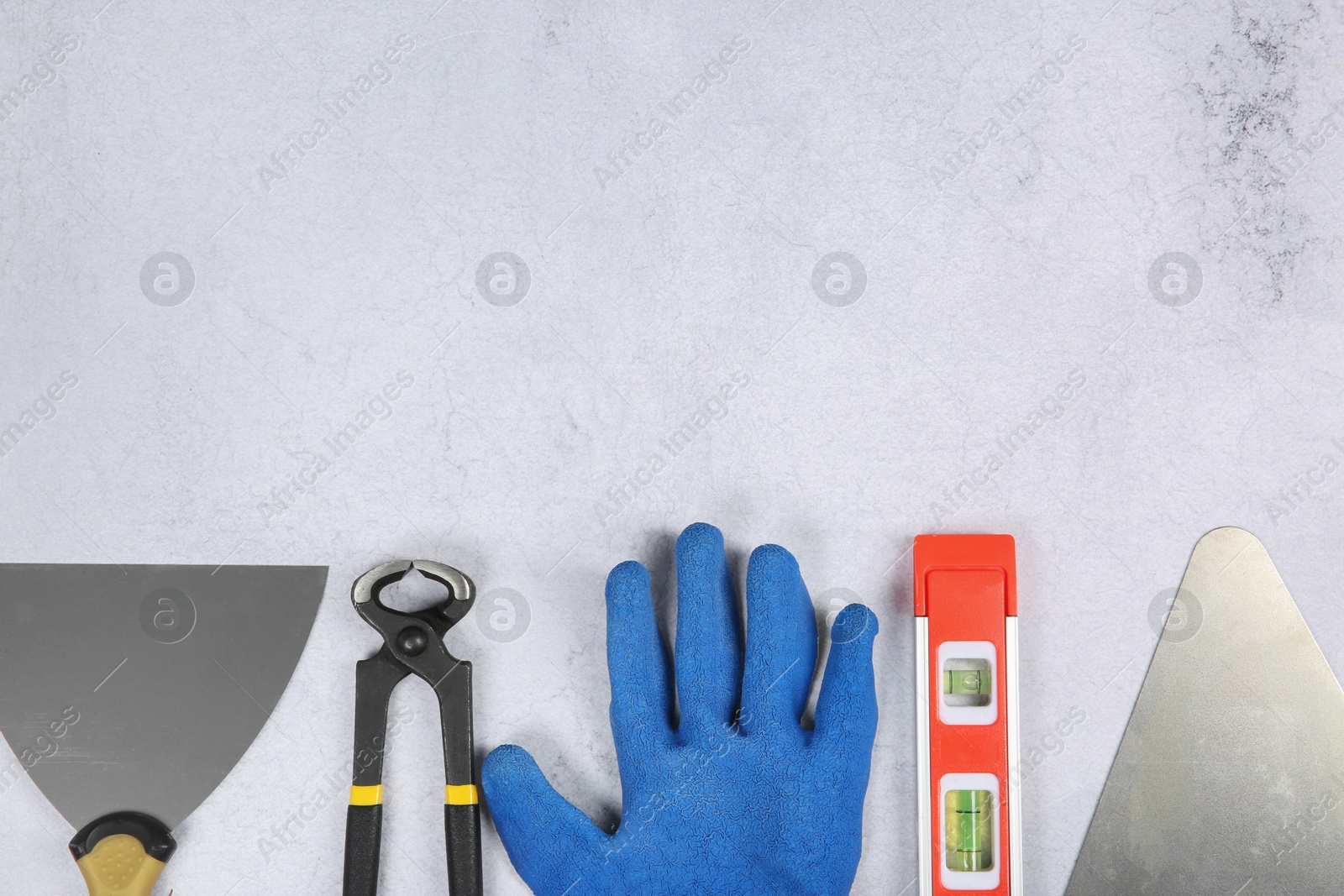 Photo of Many different construction tools on light textured table, flat lay. Space for text