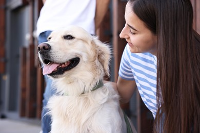 Owner with cute Golden Retriever dog outdoors