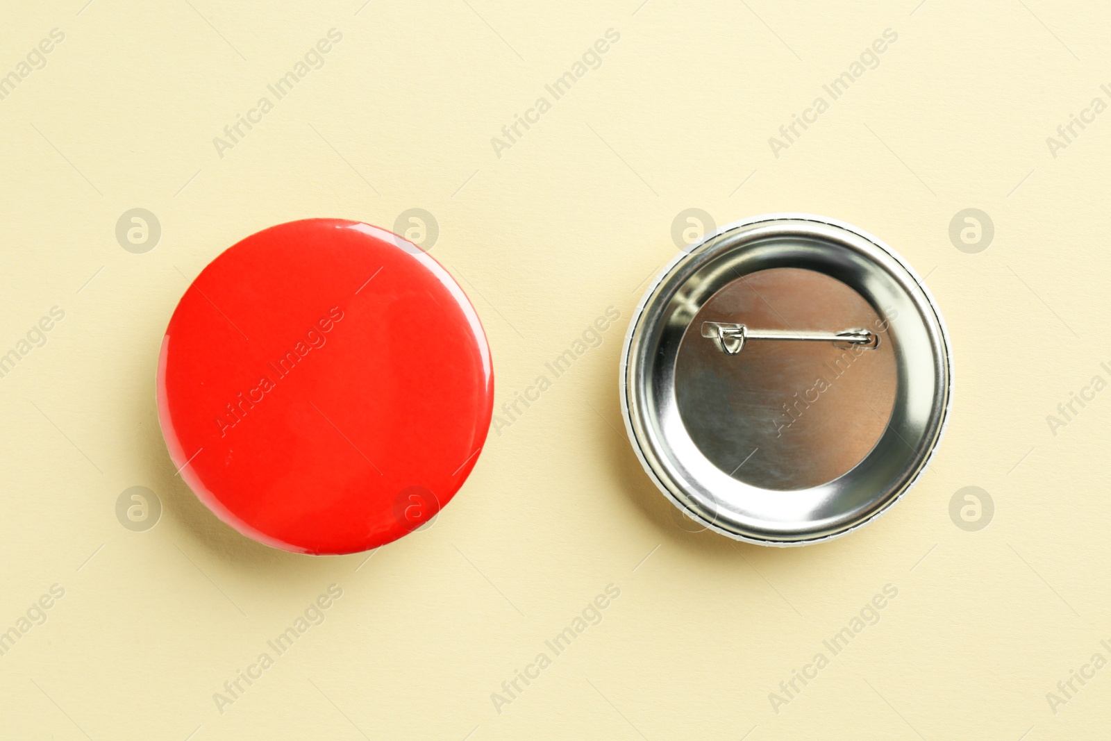 Photo of Button badges on beige background, flat lay. Mockup for design