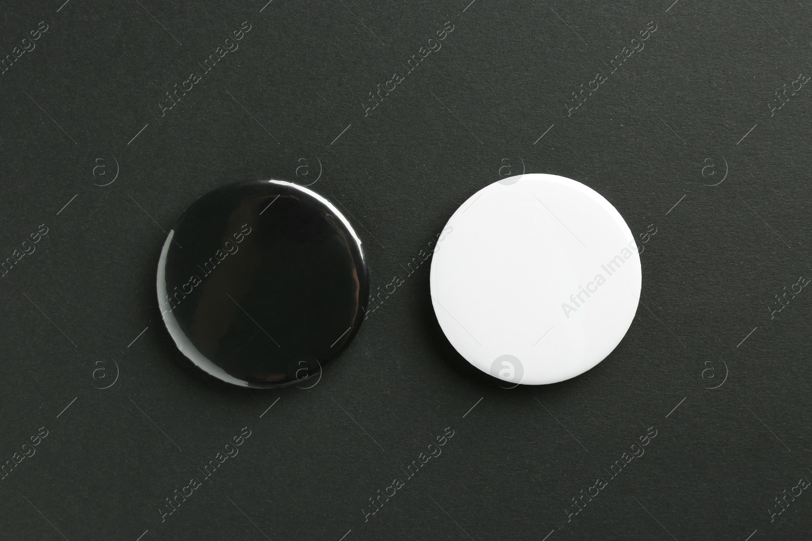 Photo of Button badges on black background, flat lay. Mockup for design