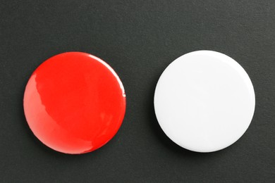 Photo of Button badges on black background, flat lay. Mockup for design