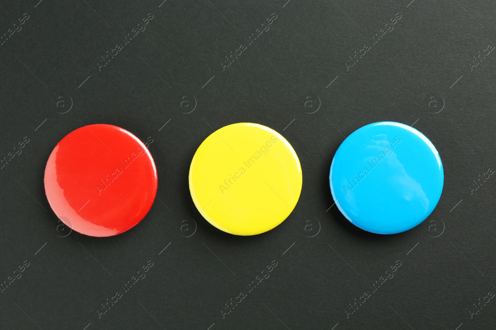 Photo of Button badges on black background, flat lay. Mockup for design