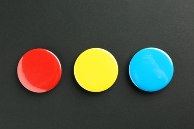 Photo of Button badges on black background, flat lay. Mockup for design