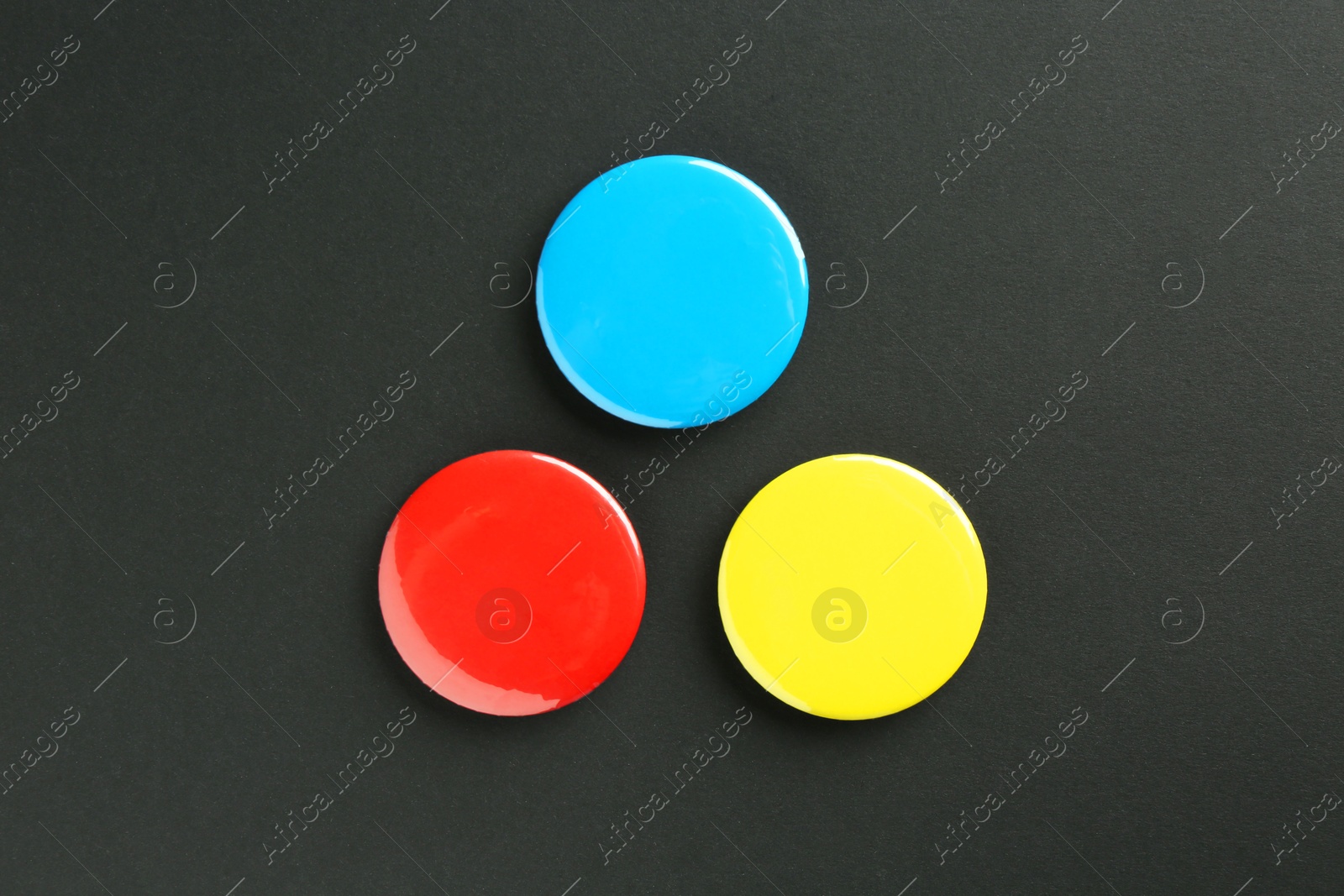 Photo of Button badges on black background, flat lay. Mockup for design