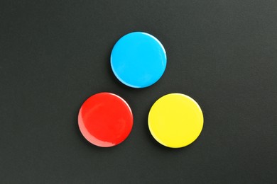 Photo of Button badges on black background, flat lay. Mockup for design