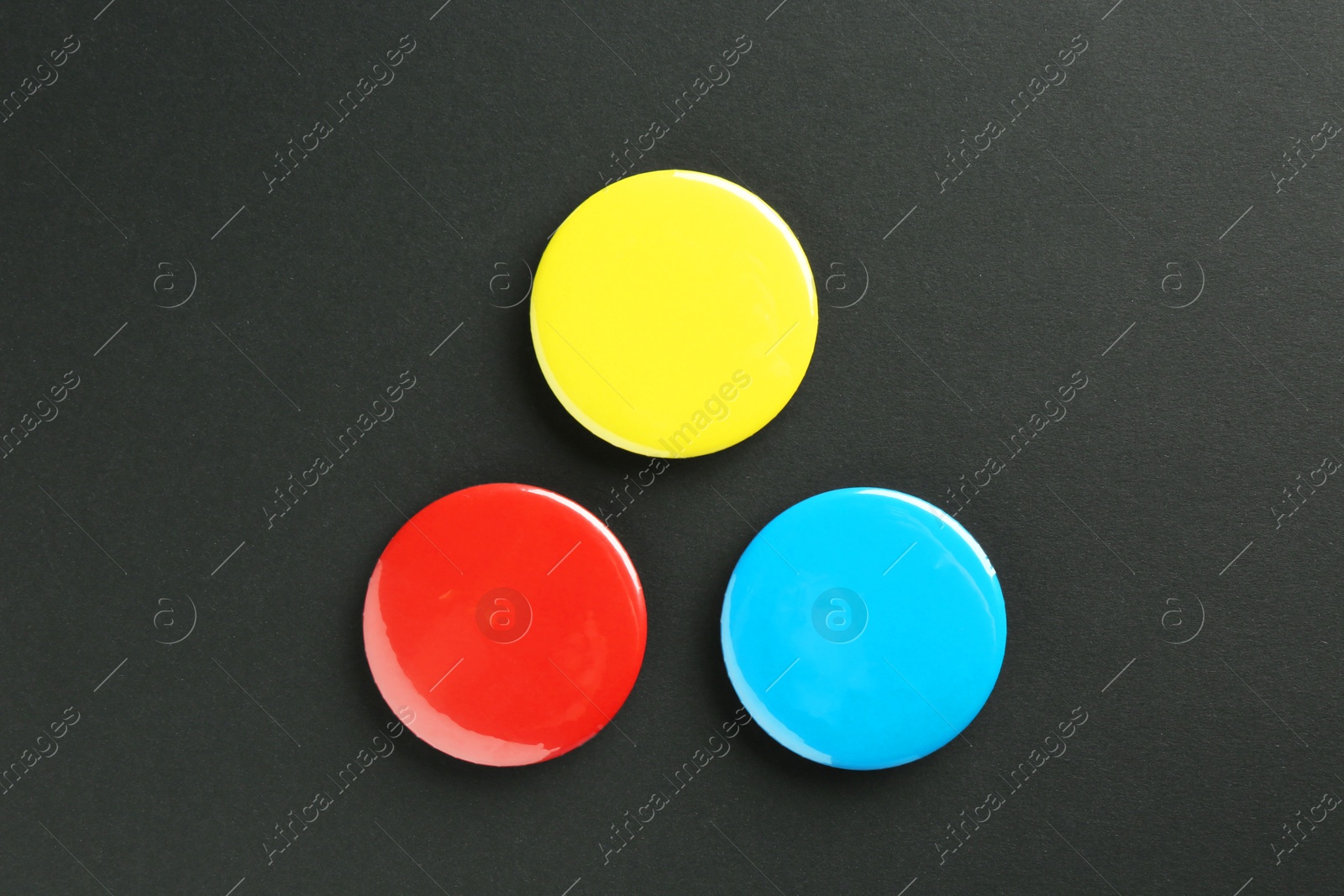 Photo of Button badges on black background, flat lay. Mockup for design