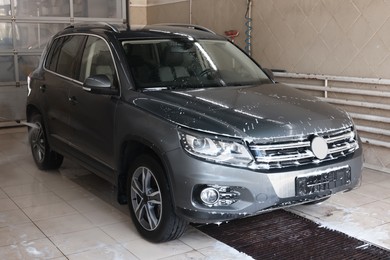 Auto covered with cleaning foam at car wash