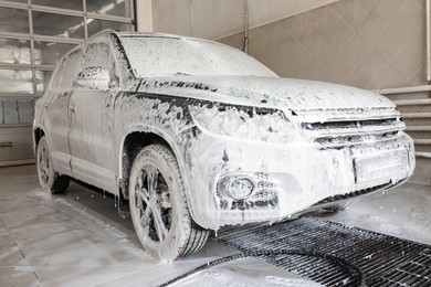 Photo of Auto covered with cleaning foam at car wash