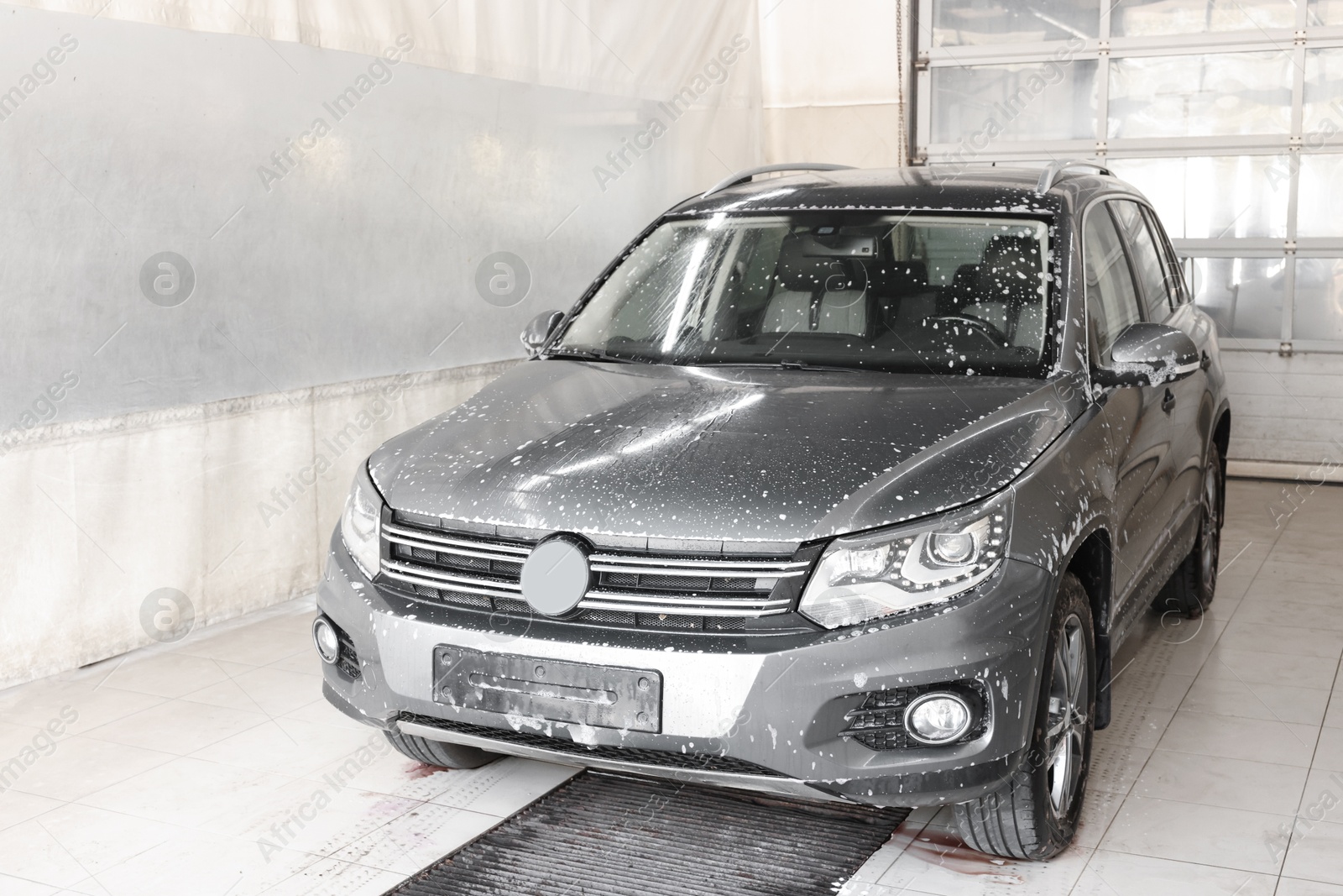 Photo of Auto covered with cleaning foam at car wash