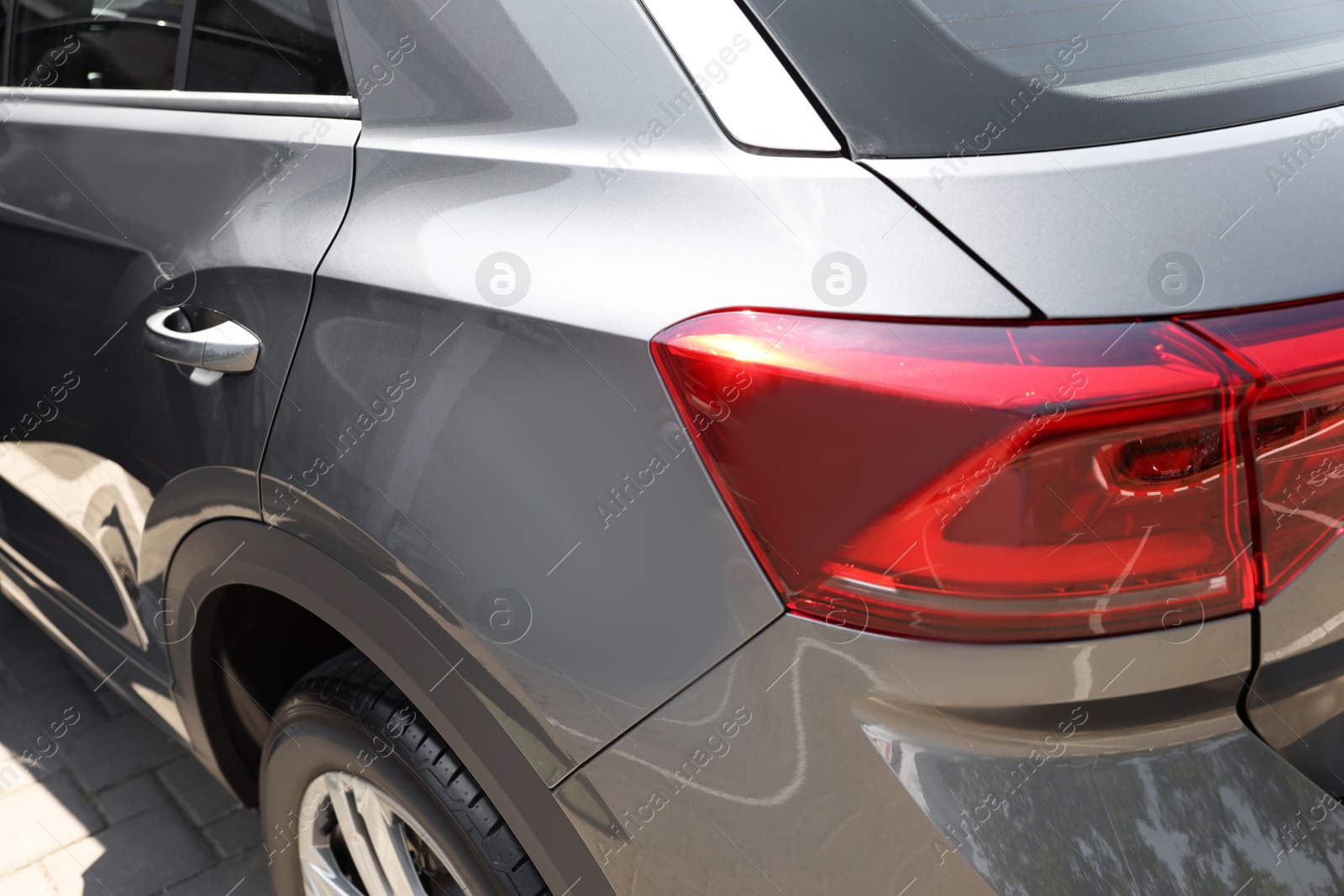 Photo of Modern grey car parked outdoors, closeup view