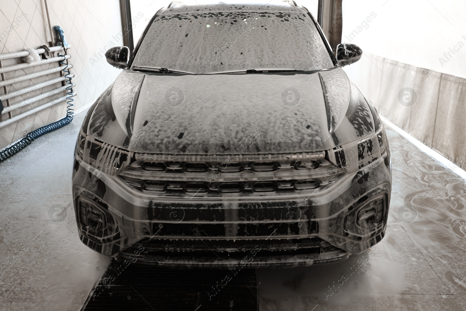 Photo of Auto covered with cleaning foam at car wash