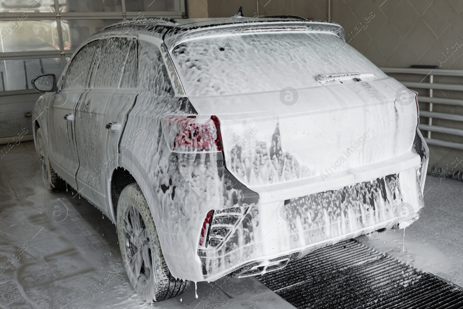 Photo of Auto covered with cleaning foam at car wash