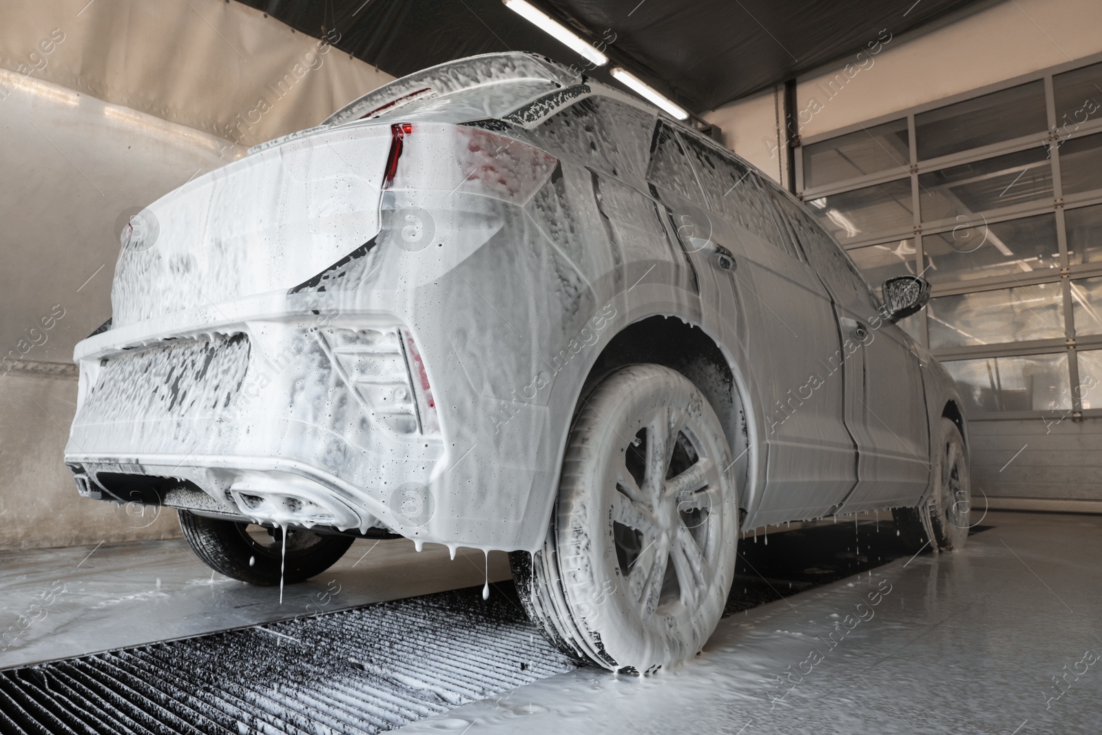 Photo of Auto covered with cleaning foam at car wash