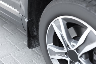 Modern grey car parked on paved road, closeup