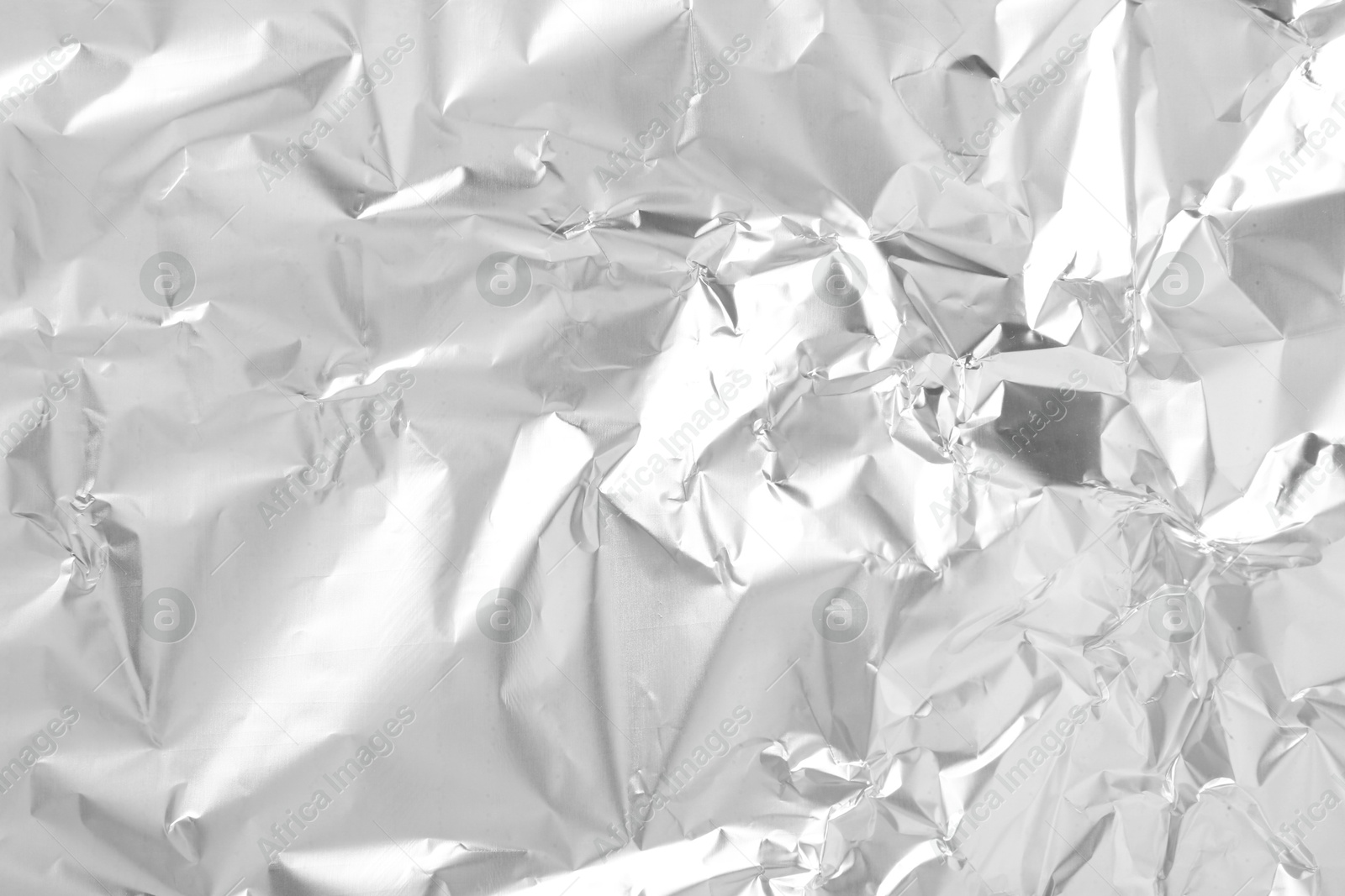 Photo of Shiny silver tinfoil surface as background, top view