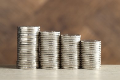 Photo of Stacked coins on light table, closeup. Salary concept