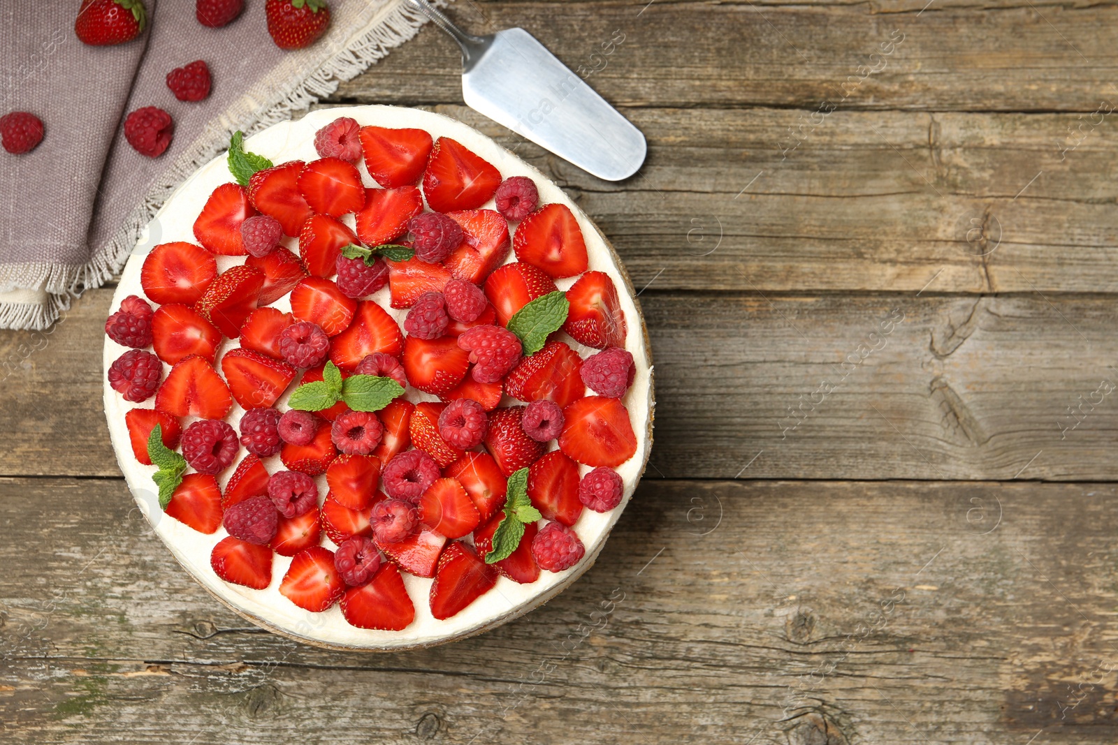 Photo of Tasty sponge cake with fresh berries and mint on wooden table, flat lay. Space for text